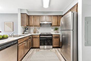 A kitchen with wooden cabinets and stainless steel appliances